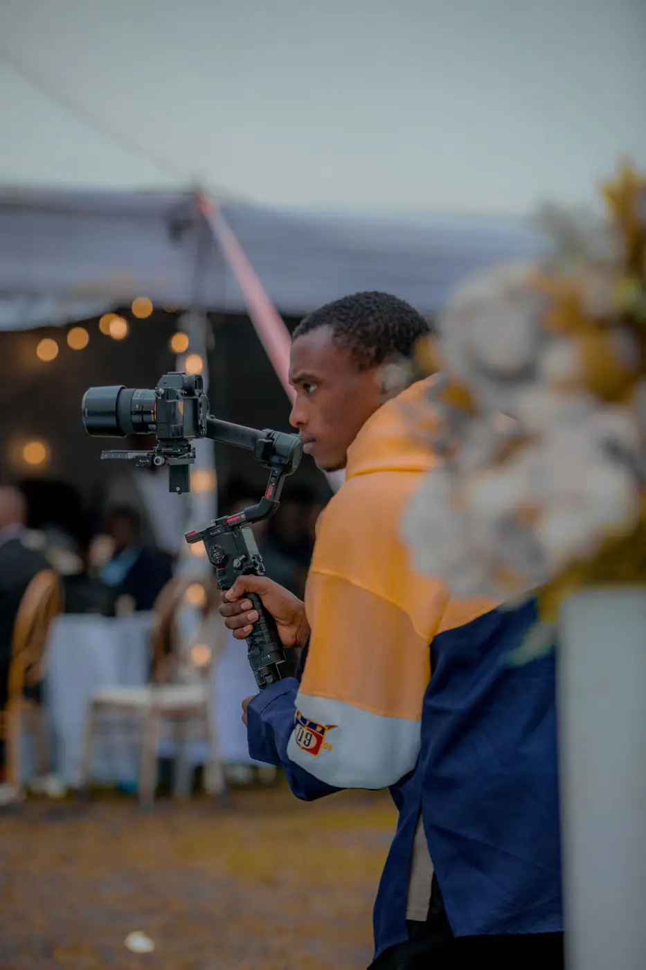 Videographer filming an outdoor wedding setup